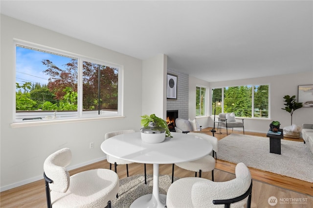 8716 Main St, Edmonds, WA 98026 - dining space featuring a fireplace and light wood finished floors