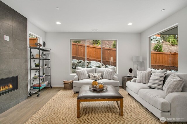 8112 131st Pl SE Unit 15, Snohomish, WA 98296 - living area featuring wood finished floors, plenty of natural light, a fireplace, recessed lighting, and baseboards