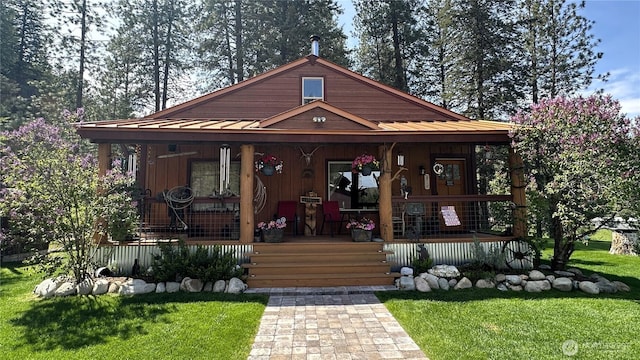 26 Newby Creek Rd, Twisp, WA 98856 - view of front facade featuring covered porch, a front lawn, metal roof, and a standing seam roof