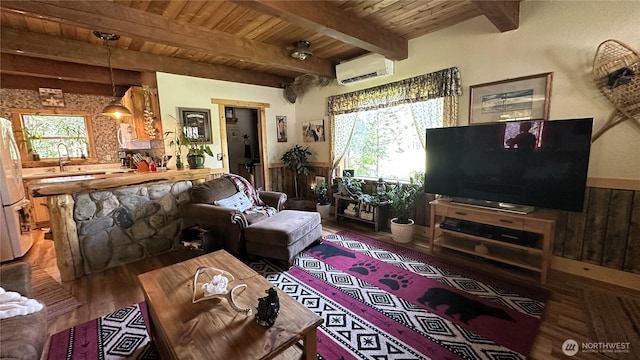 26 Newby Creek Rd, Twisp, WA 98856 - living room featuring an AC wall unit, wood finished floors, wooden ceiling, and beam ceiling