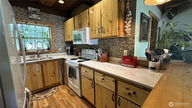 26 Newby Creek Rd, Twisp, WA 98856 - kitchen featuring white appliances, light countertops, light wood-style floors, tasteful backsplash, and a sink