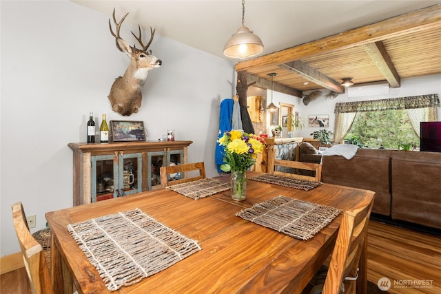 26 Newby Creek Rd, Twisp, WA 98856 - dining area featuring a wall mounted AC, wood finished floors, and a wood ceiling with exposed beams