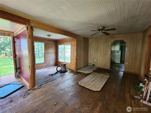 175 Stevens Rd, Chehalis, WA 98532 - unfurnished living room featuring hardwood / wood-style floors, arched walkways, wood walls, and a ceiling fan
