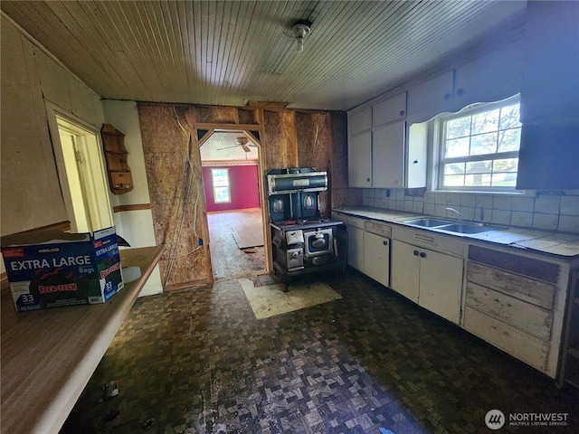 175 Stevens Rd, Chehalis, WA 98532 - kitchen featuring a sink, decorative backsplash, and white cabinets