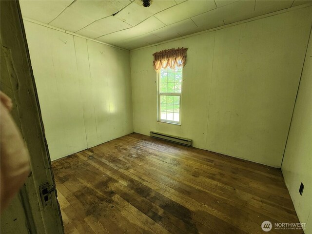 175 Stevens Rd, Chehalis, WA 98532 - empty room with a baseboard radiator and wood-type flooring