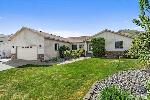 649 Sally Dr, Wenatchee, WA 98801 - ranch-style home with an attached garage, driveway, a front lawn, and stone siding