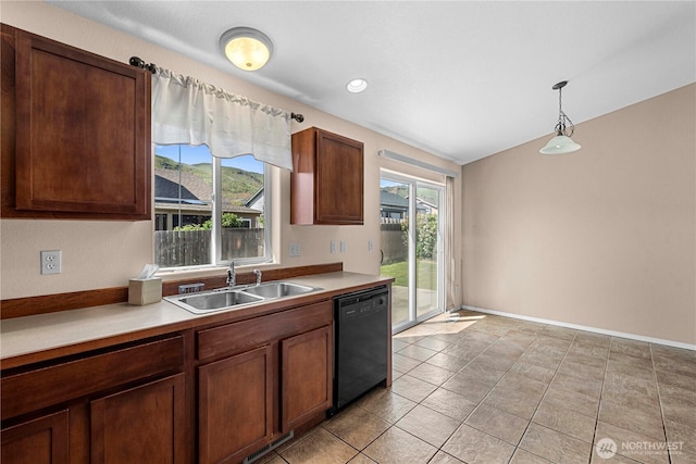 649 Sally Dr, Wenatchee, WA 98801 - kitchen with black dishwasher, a sink, light countertops, and hanging light fixtures