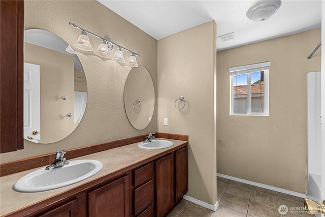 649 Sally Dr, Wenatchee, WA 98801 - bathroom with tile patterned flooring, double vanity, baseboards, and a bath