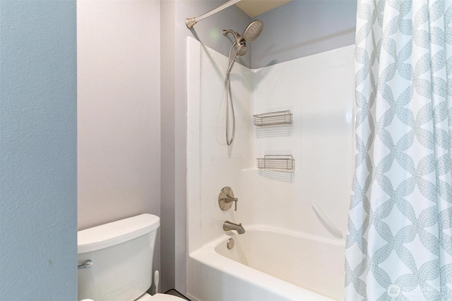 bathroom featuring toilet and shower / tub combo with curtain