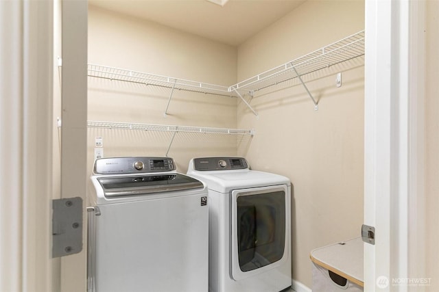 laundry room featuring washing machine and clothes dryer