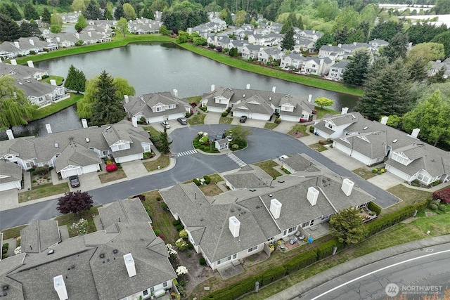 aerial view of residential area featuring a large body of water