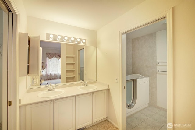full bathroom featuring ensuite bathroom, double vanity, and tile patterned floors