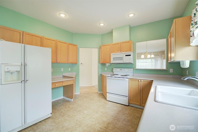 kitchen with white appliances, a sink, light countertops, a chandelier, and recessed lighting