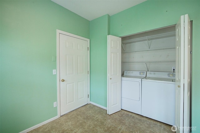 laundry area featuring washer and clothes dryer and baseboards