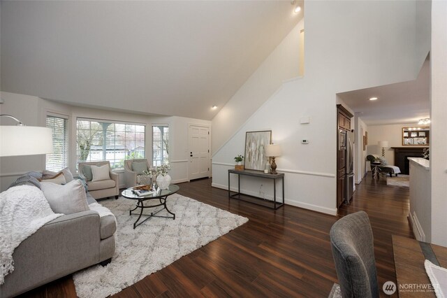 11635 NE 95th St, Kirkland, WA 98033 - living area featuring dark wood-style floors, a fireplace, high vaulted ceiling, and baseboards