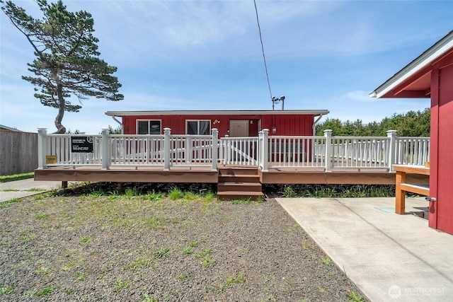 1011 231st Ln, Ocean Park, WA 98640 - back of property featuring a wooden deck, a patio area, and board and batten siding
