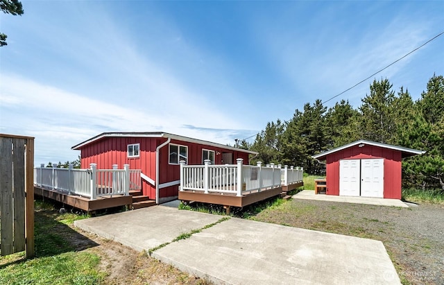 1011 231st Ln, Ocean Park, WA 98640 - rear view of property with board and batten siding, a deck, and a patio area