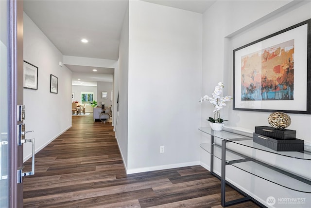hall featuring dark wood finished floors, recessed lighting, and baseboards