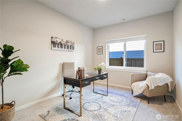 carpeted home office featuring baseboards