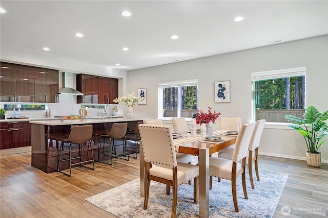 dining space featuring recessed lighting, light wood-type flooring, and baseboards