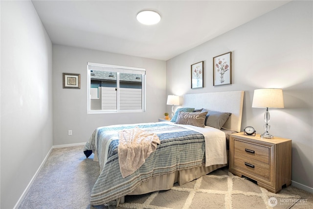 bedroom with light colored carpet and baseboards