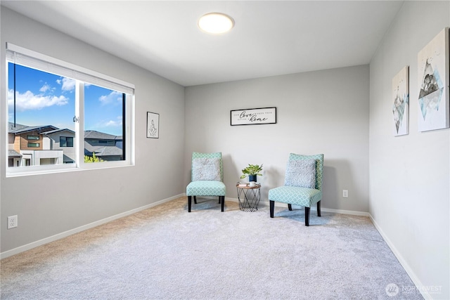 sitting room with carpet flooring and baseboards