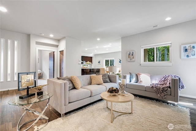 living area featuring wood finished floors, recessed lighting, and baseboards