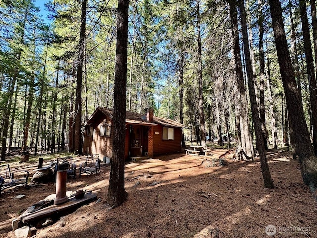 511 Old River Rd Unit 18, Naches, WA 98937 - view of side of property with a chimney and a view of trees