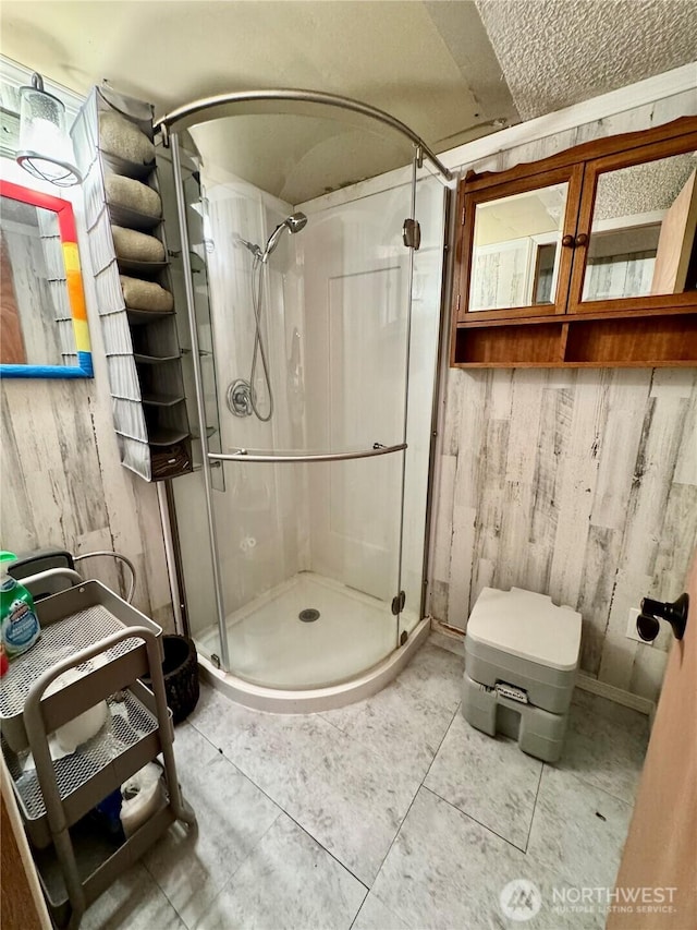 511 Old River Rd Unit 18, Naches, WA 98937 - bathroom featuring a stall shower and wooden walls