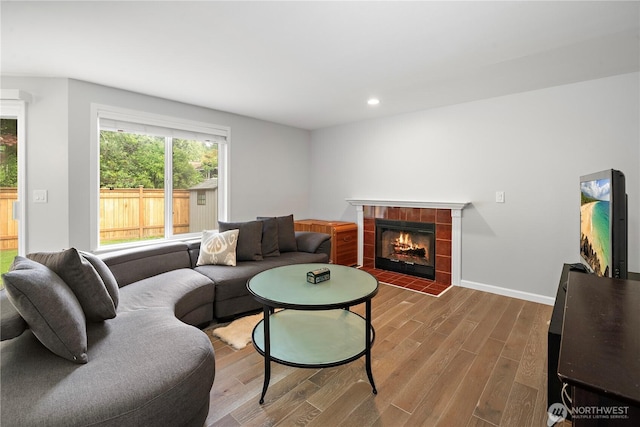 16260 11th Ave NE, Shoreline, WA 98155 - living area featuring a tiled fireplace, wood finished floors, recessed lighting, and baseboards