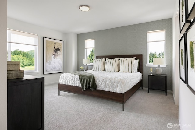 bedroom with light carpet and baseboards