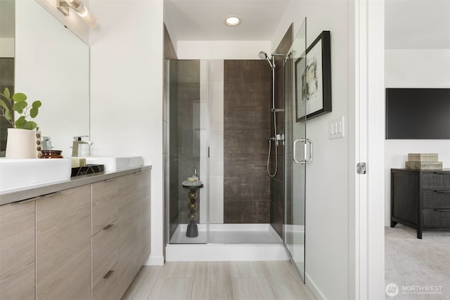 full bathroom with a shower stall, vanity, and recessed lighting