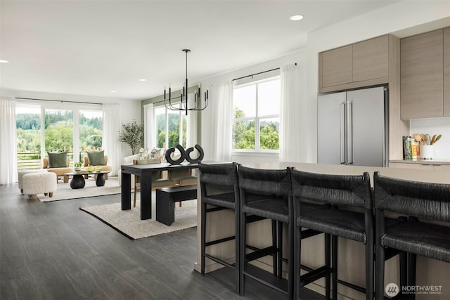 dining space with dark wood-type flooring and recessed lighting
