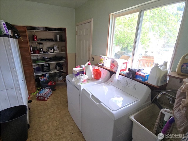 clothes washing area featuring washer and dryer and tile patterned floors