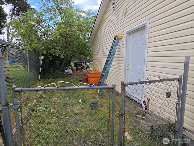 view of exterior entry with a gate and fence