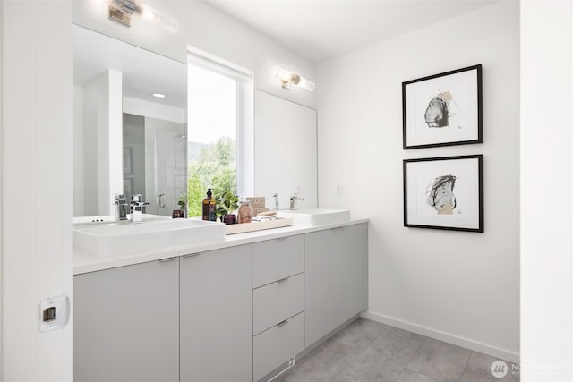 full bathroom featuring double vanity, baseboards, an enclosed shower, and tile patterned floors