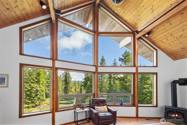 6166 Westside Rd, Cle Elum, WA 98922 - sunroom with a wood stove, wooden ceiling, plenty of natural light, high vaulted ceiling, and wood finished floors