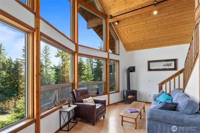 6166 Westside Rd, Cle Elum, WA 98922 - living area with wooden ceiling, healthy amount of natural light, a wood stove, high vaulted ceiling, and light wood-style floors