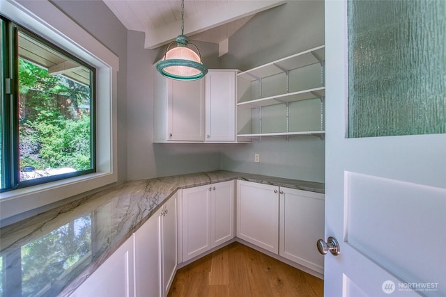 376 Killebrew Lake Rd, Orcas Island, WA 98280 - kitchen with plenty of natural light, white cabinetry, light wood-style floors, light stone countertops, and lofted ceiling