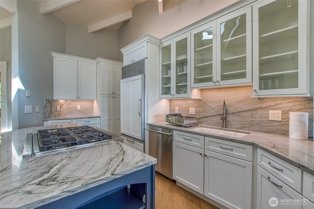 376 Killebrew Lake Rd, Orcas Island, WA 98280 - kitchen featuring a sink, stainless steel appliances, decorative backsplash, light stone countertops, and white cabinetry
