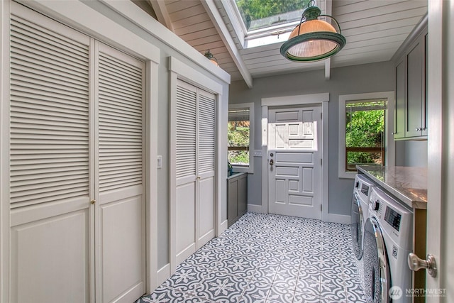 376 Killebrew Lake Rd, Orcas Island, WA 98280 - laundry area with independent washer and dryer, a skylight, wooden ceiling, baseboards, and light tile patterned floors