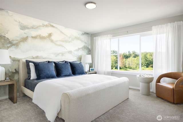 carpeted bedroom featuring baseboards