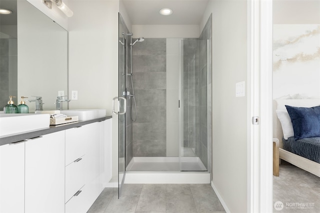 ensuite bathroom with a stall shower, recessed lighting, baseboards, vanity, and tile patterned flooring