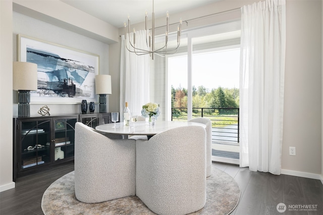 dining space featuring a chandelier, dark wood-style flooring, and baseboards