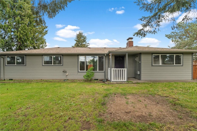 view of front of property with a chimney and a front lawn