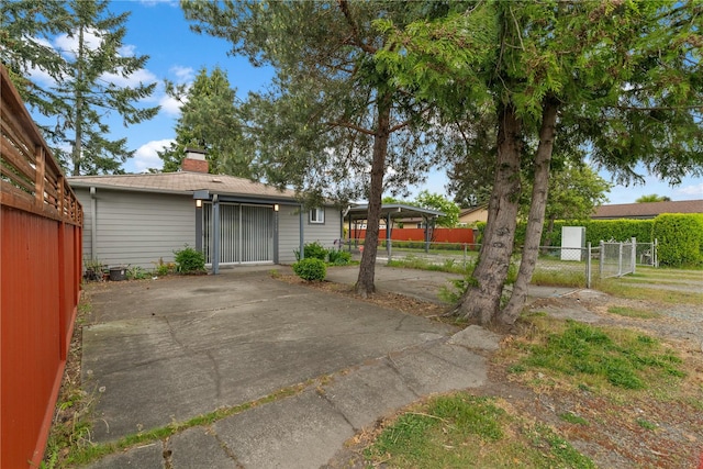 exterior space featuring a chimney and fence