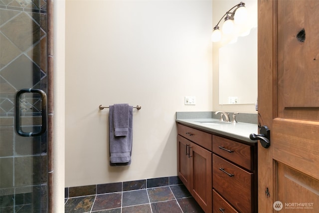 1041 Red Sky Dr, Yakima, WA 98903 - bathroom featuring vanity, stone finish floors, and a shower with door