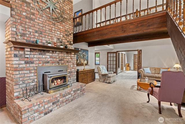 14413 139th Ave SE, Snohomish, WA 98290 - living room featuring carpet, a lit fireplace, and a high ceiling