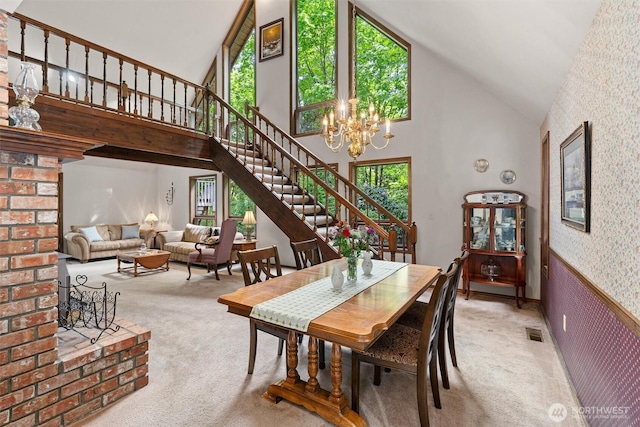 14413 139th Ave SE, Snohomish, WA 98290 - dining space with carpet floors, stairs, high vaulted ceiling, wallpapered walls, and a chandelier