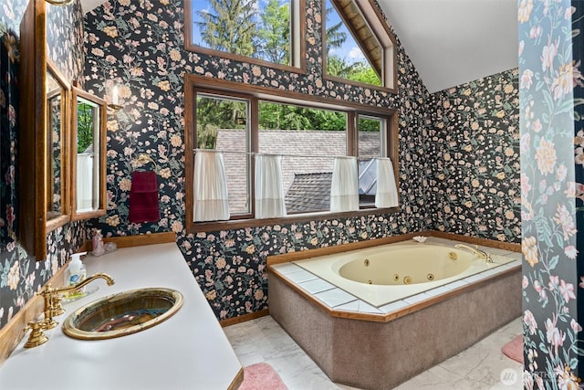 14413 139th Ave SE, Snohomish, WA 98290 - full bathroom with marble look tiles, wallpapered walls, lofted ceiling, a tub with jets, and vanity